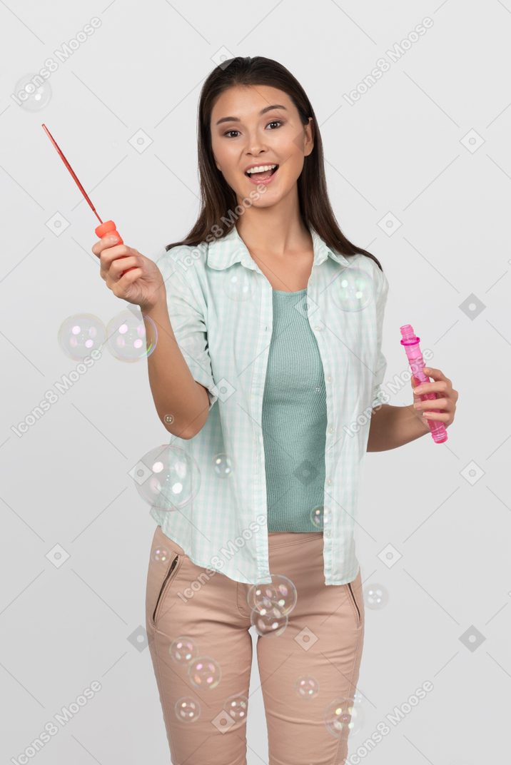 Happy woman blowing soap bubbles