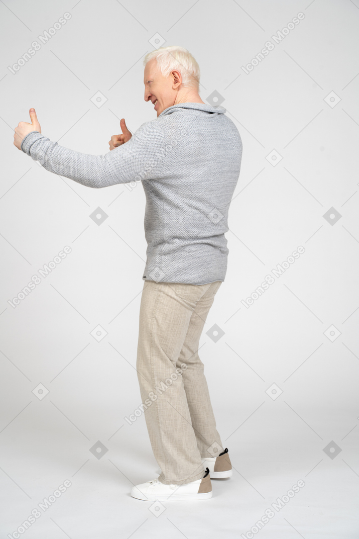 Side view of man giving thumbs up with two hands