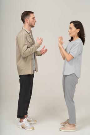 Side view of young couple speaking to each other