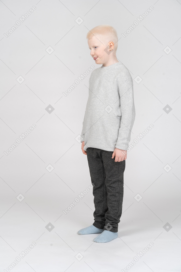 Three-quarter view of a kid boy showing tongue