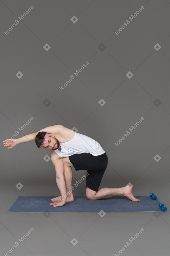 Man doing yoga exercises in the studio