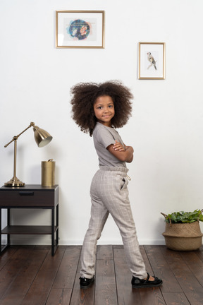 Good looking girl kid posing on the apartment background