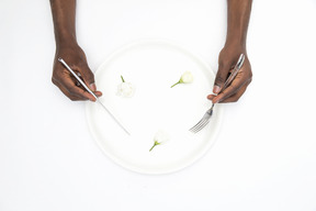 Black male hands holding fork and knife