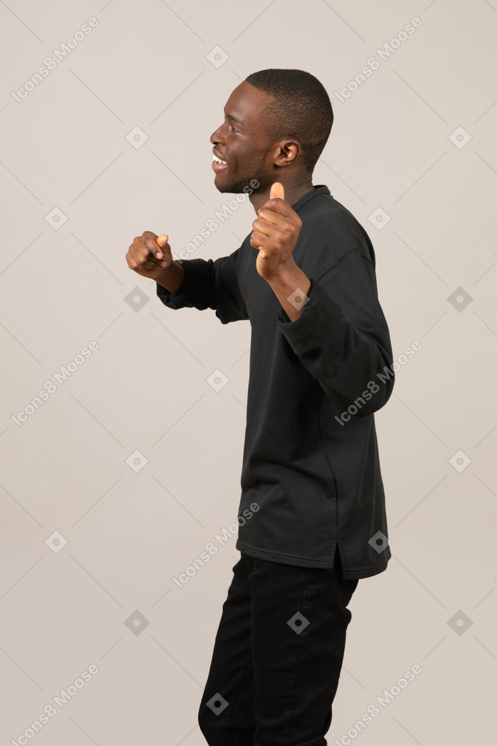Side view of a cheerful man dancing