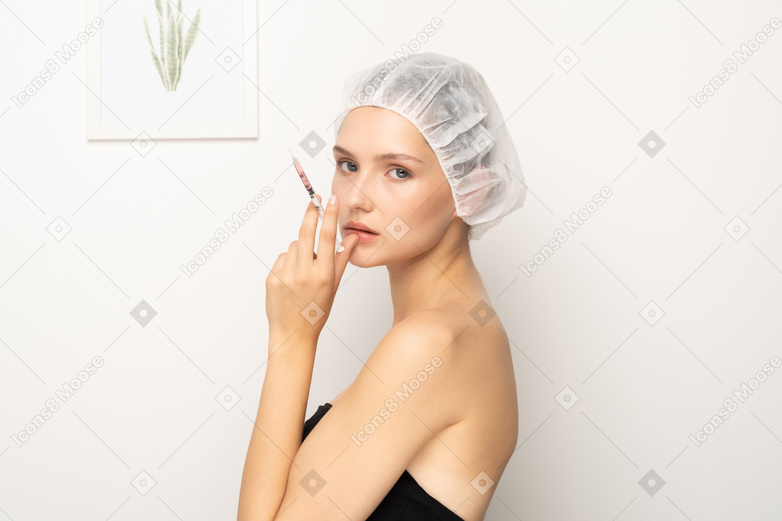 Woman holding syringe while looking at camera