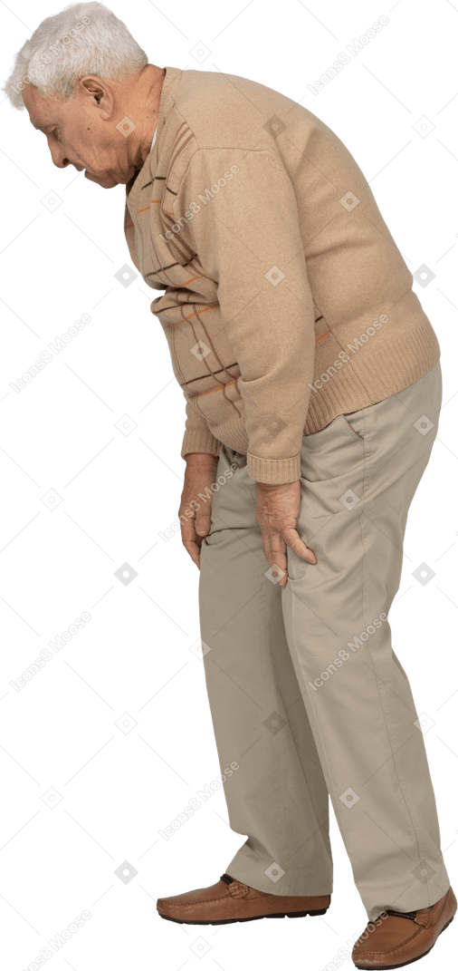 Side view of an old man in casual clothes bending down