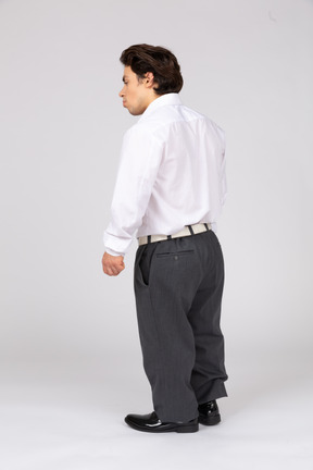 Three-quarter back view of a man in business casual clothes