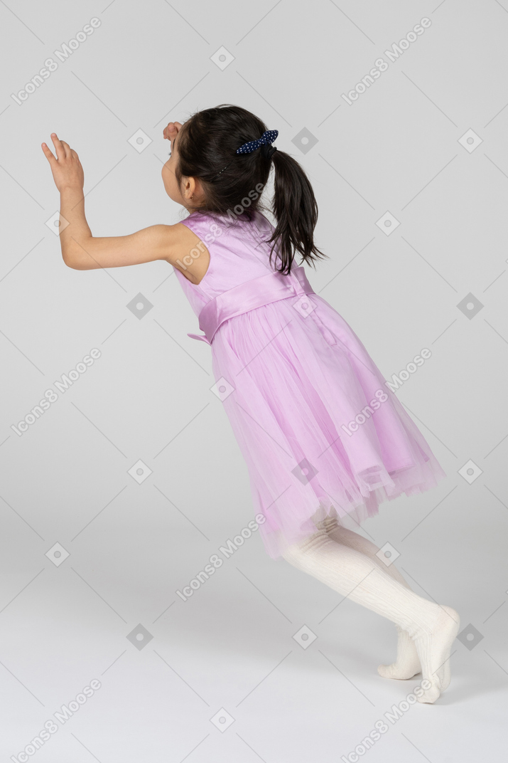 Girl in pink dress falling forward