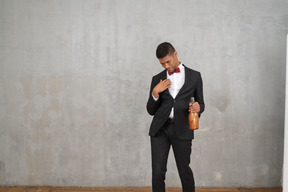 Drunk man walking with a bottle in his hand