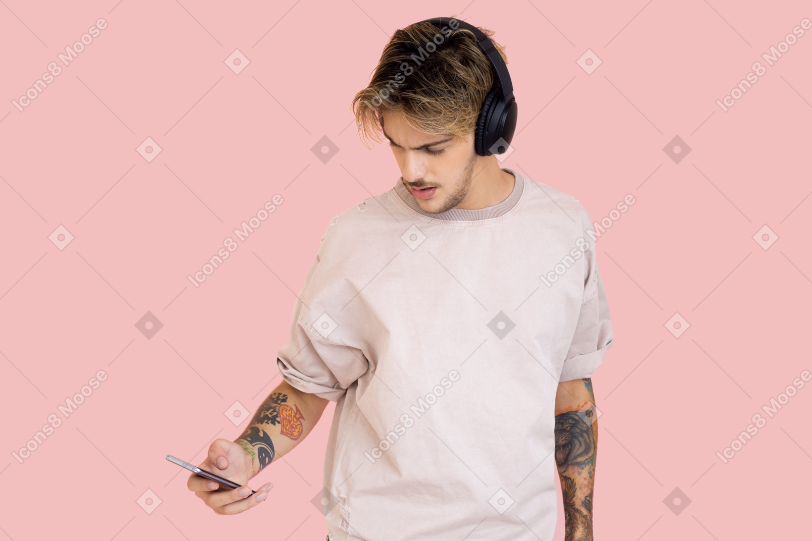 Young man in headphones holding smartphone