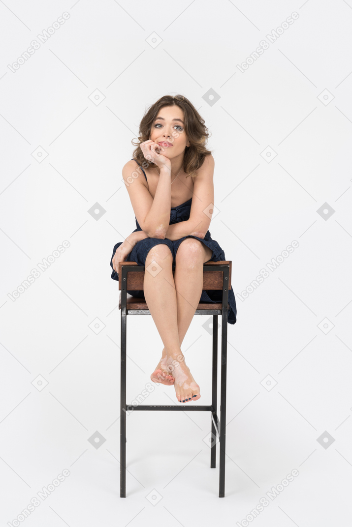 Bored woman holding head while sitting on a bar chair
