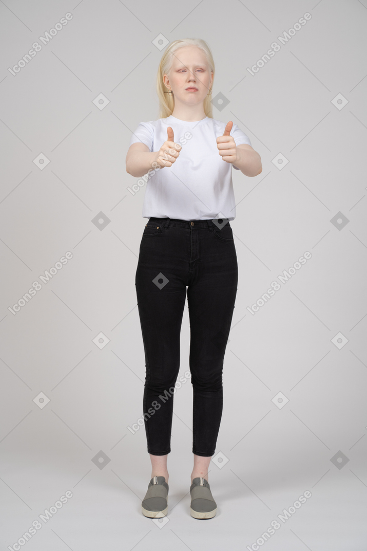 Front view of a young girl showing two thumbs up