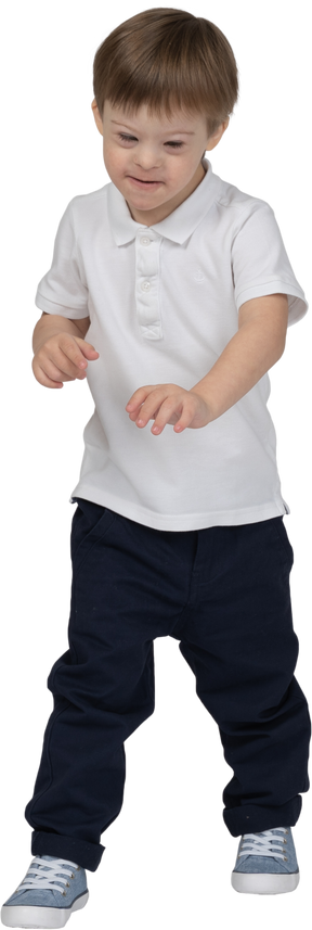 Front view of a boy stepping forward and looking down smiling