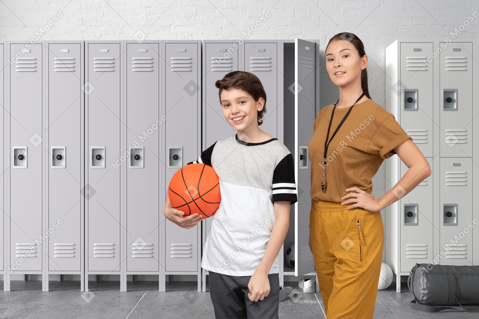 Boy with basketball standing next to female trainer