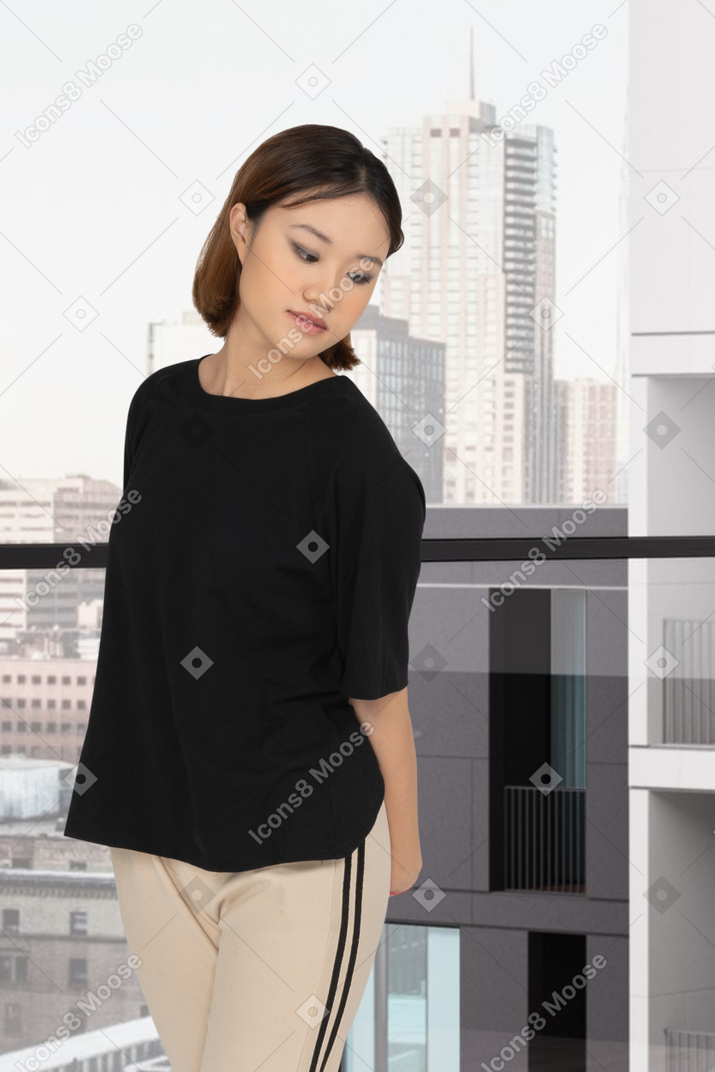 A woman in a black top and tan pants