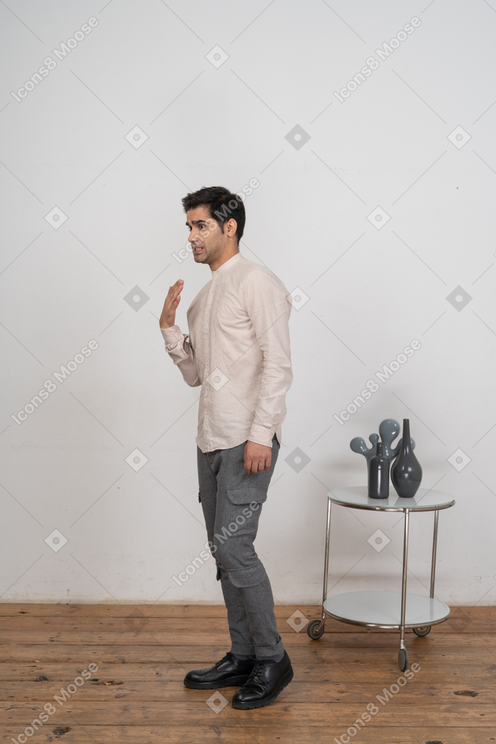 Side view of a man in shirt gesturing