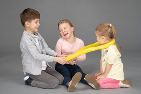 Kids having fun playing with yellow balloon