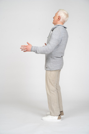 一个男人用弯曲的手臂站立的侧视图