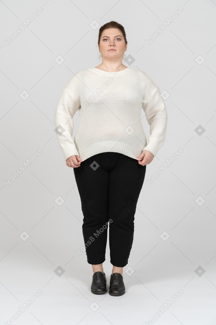 Serious plump woman in casual clothes looking at camera