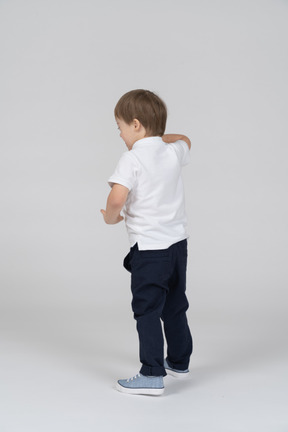 Back view of boy gesturing