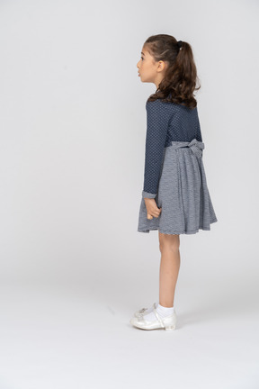 Three-quarter back view of a girl leaning forward slightly