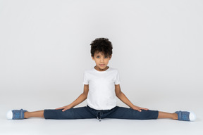 A boy doing split exercise