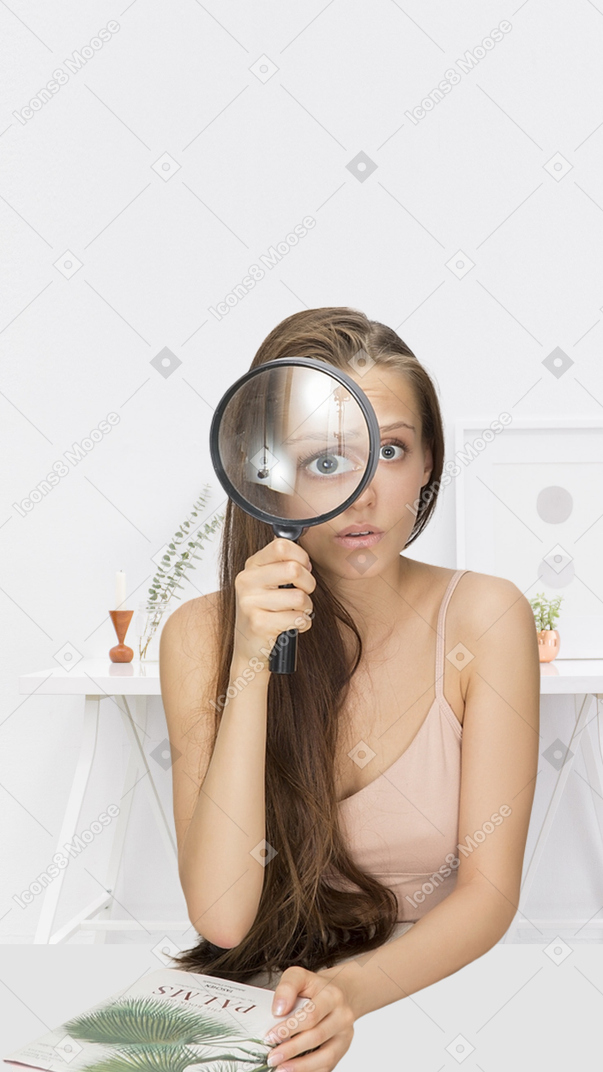 A woman looking through a magnifying glass