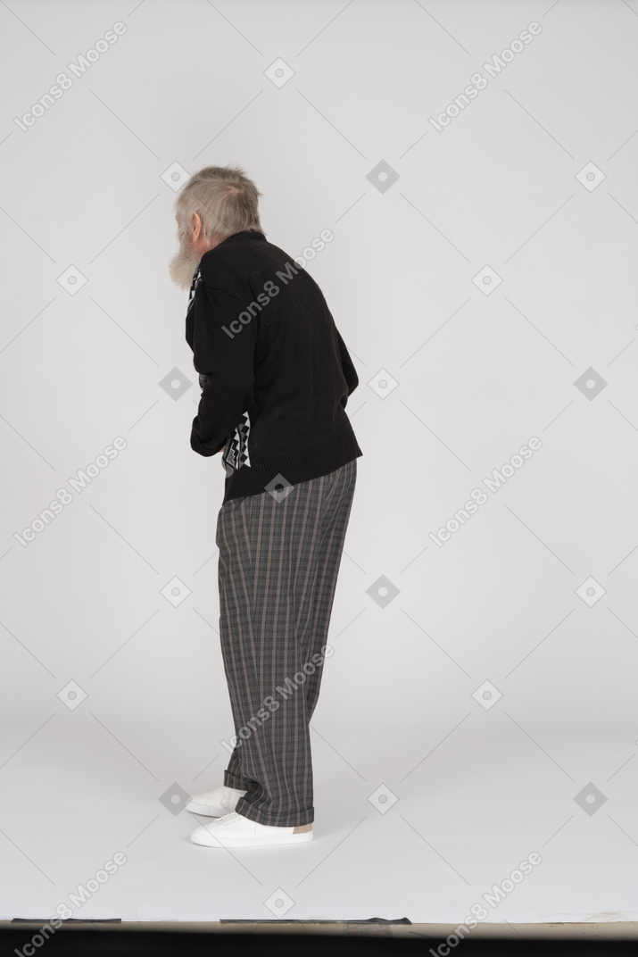 Rear view of old man groaning with pain