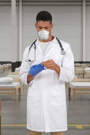 Laboratory worker taking off a medical glove