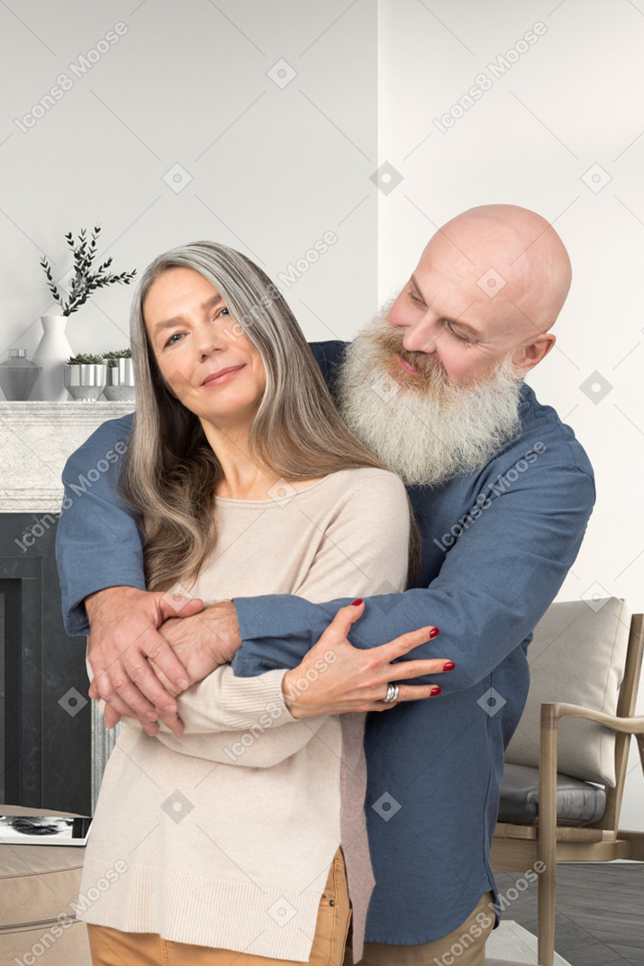 A man hugging a woman in a living room
