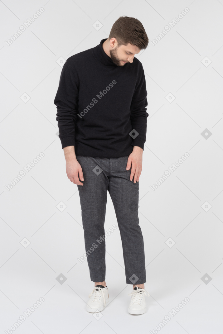 Young caucasian man looking down to the floor