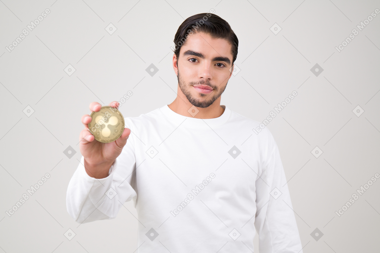 Attractive young man holding a ripple coin