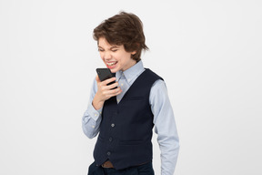 Angry schoolboy using his smartphone