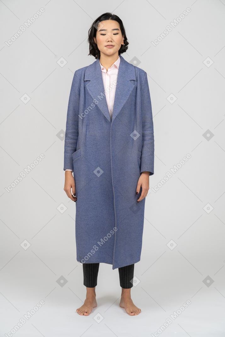 Woman with closed eyes wearing a blue coat