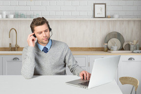 Customer service employee listening to customer using headphones