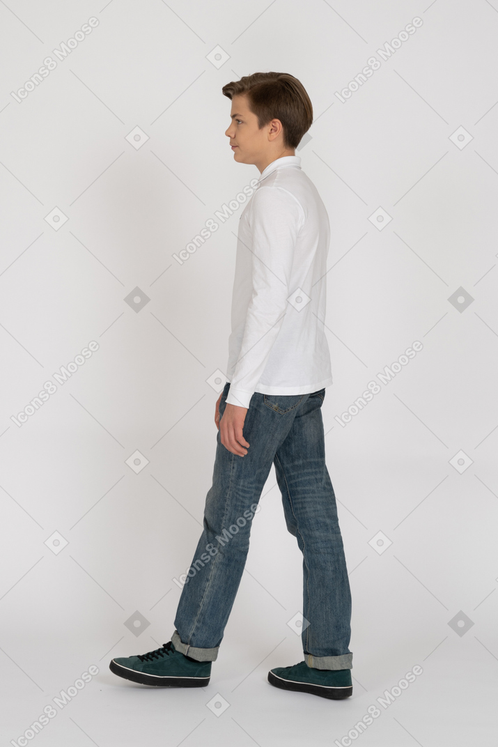 Young man in casual clothes walking