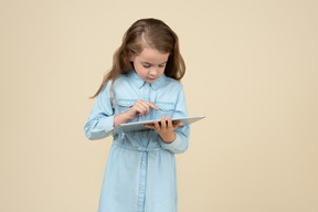 Mignonne petite fille à l'aide d'une tablette