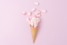 Ice cream cone full of pink marshmallows