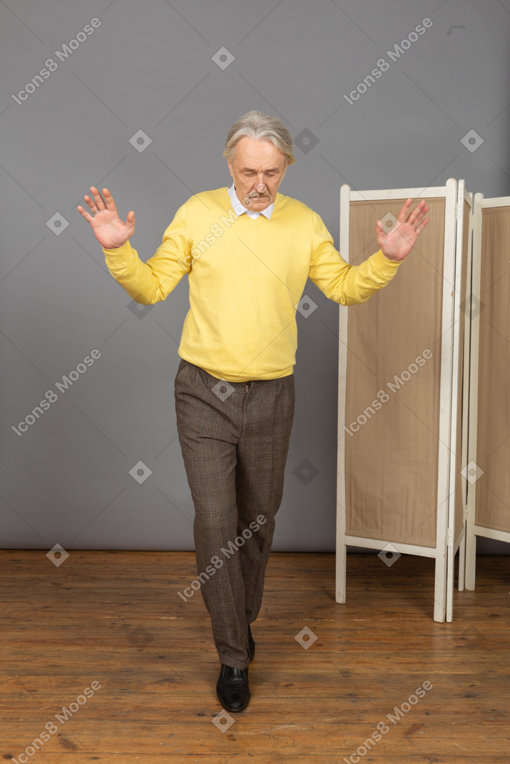 Front view of a balancing walking old man