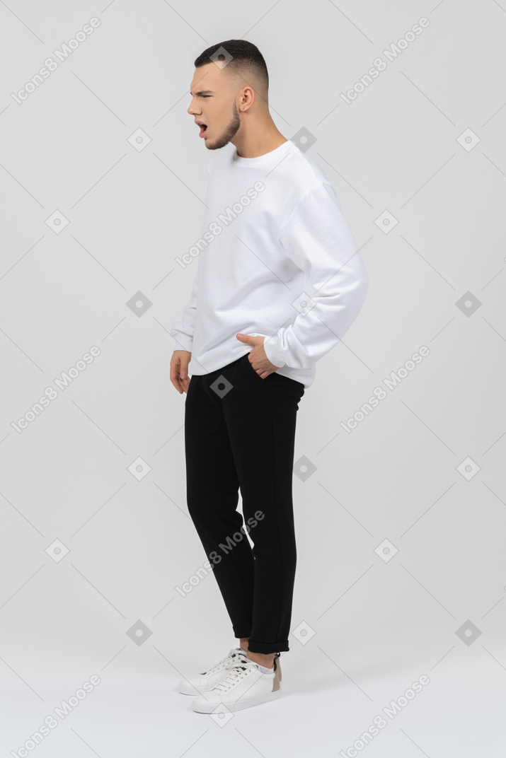 Young man in casual clothes looking disgusted