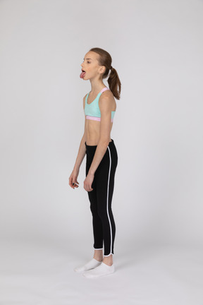 Side view of a teen girl in sportswear raising hand and arguing