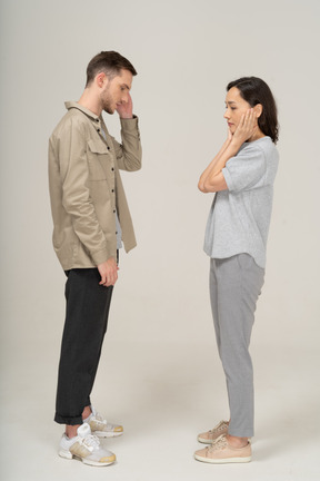 Side view of young couple speaking to each other