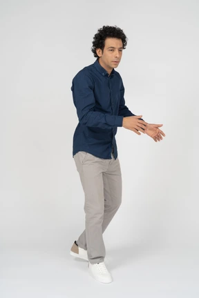 Side view of a man in casual clothes gesturing