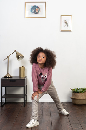 Cute girl kid posing on the apartments background