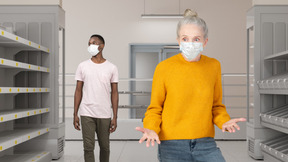 A man and a woman wearing masks in a room with empty shelves