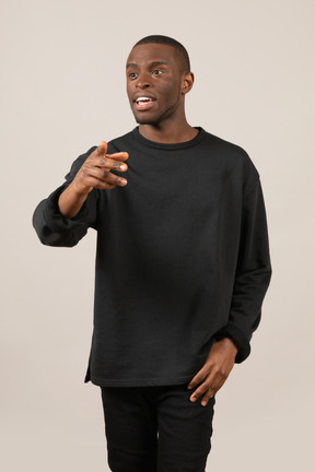 Young man talking and gesturing with one hand