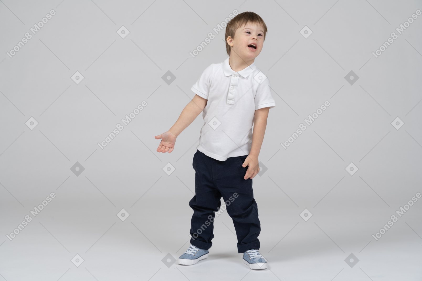 Distracted little boy in casual clothes standing