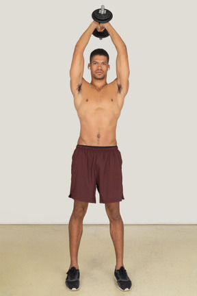 Athletic man doing exercises with dumbbell