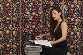 Woman following musical notation while playing piano