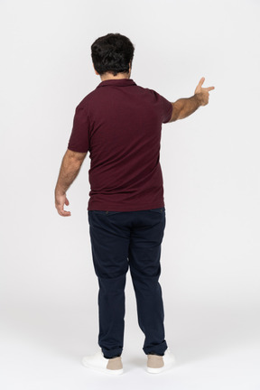 Back view of a man making a finger gun